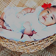 Angelina participe au concours pour gagner de l'argent avec cette photo : baby, infant, basket, flower, white_dress, lying_down, woven_mat, woven_basket, face, portrait, cute, child, soft_light, skin, head, hands, feet, indoors, decor, resting