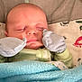 baby, sleeping, blanket, mittens, infant, cozy, face, bed, cushion, pattern, footprints, clothing, soft, peaceful, resting, child, closeup, indoors, cute, young