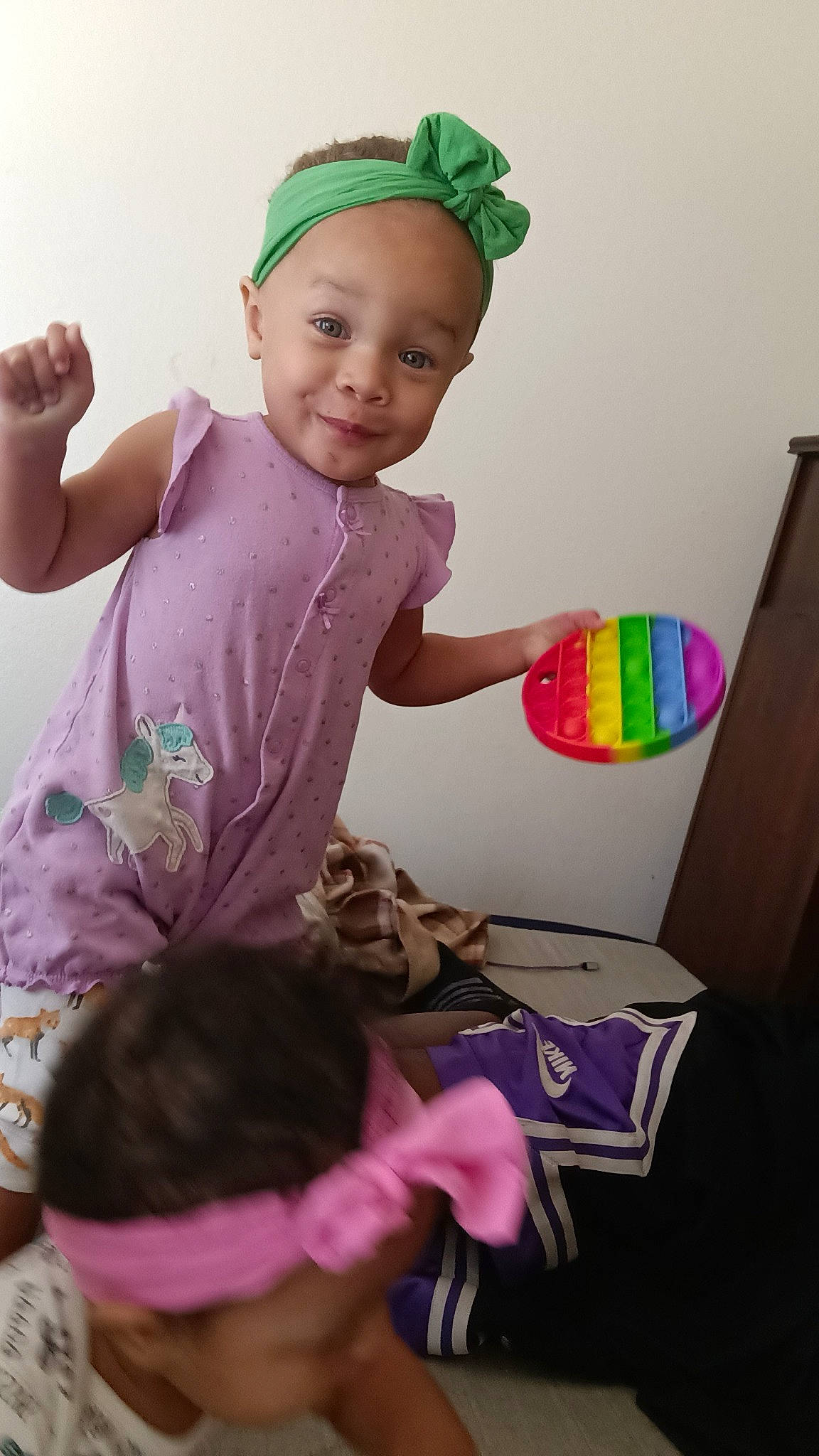 Harmony is registered to the contest to win money with this photo: baby, baby_toddler_clothing, cap, child, finger, fun, hand, happy, joy, magenta, party_supply, person, pink, play, purple, room, sitting, sleeve, smile, t_shirt