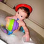 Amelia is registered to the contest to win money with this photo: toddler, bath, bathtub, bubbles, toy, child, foam, water, red_ring, floating_toy, play, cute, skin, hair, indoor, fun, cleaning, infant, bath_time, childhood