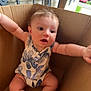 Amelia joined the competition — help win amazing prizes! baby, child, cardboard_box, onesie, arms_outstretched, sitting, curious, outdoor, bench, house_siding, grass, window, door, red_car, feet, face, skin, hair, expression, daylight