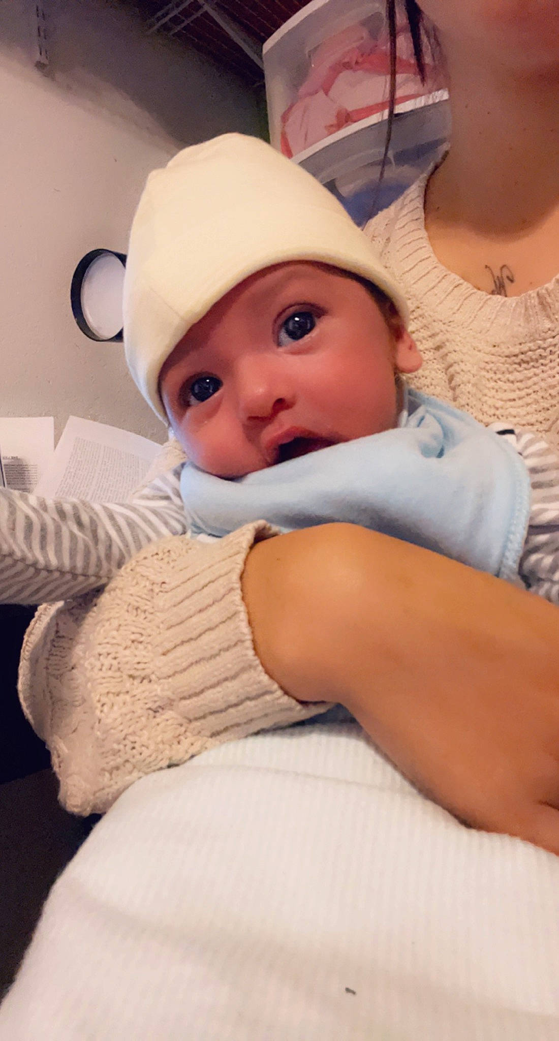 Emilio is registered to the contest to win money with this photo: abdomen, baby, baby_sleeping, baby_toddler_clothing, bedding, cap, cheek, child, comfort, eyelash, fashion_accessory, finger, headgear, headwear, human_body, linens, person, sitting, skin, sleeve