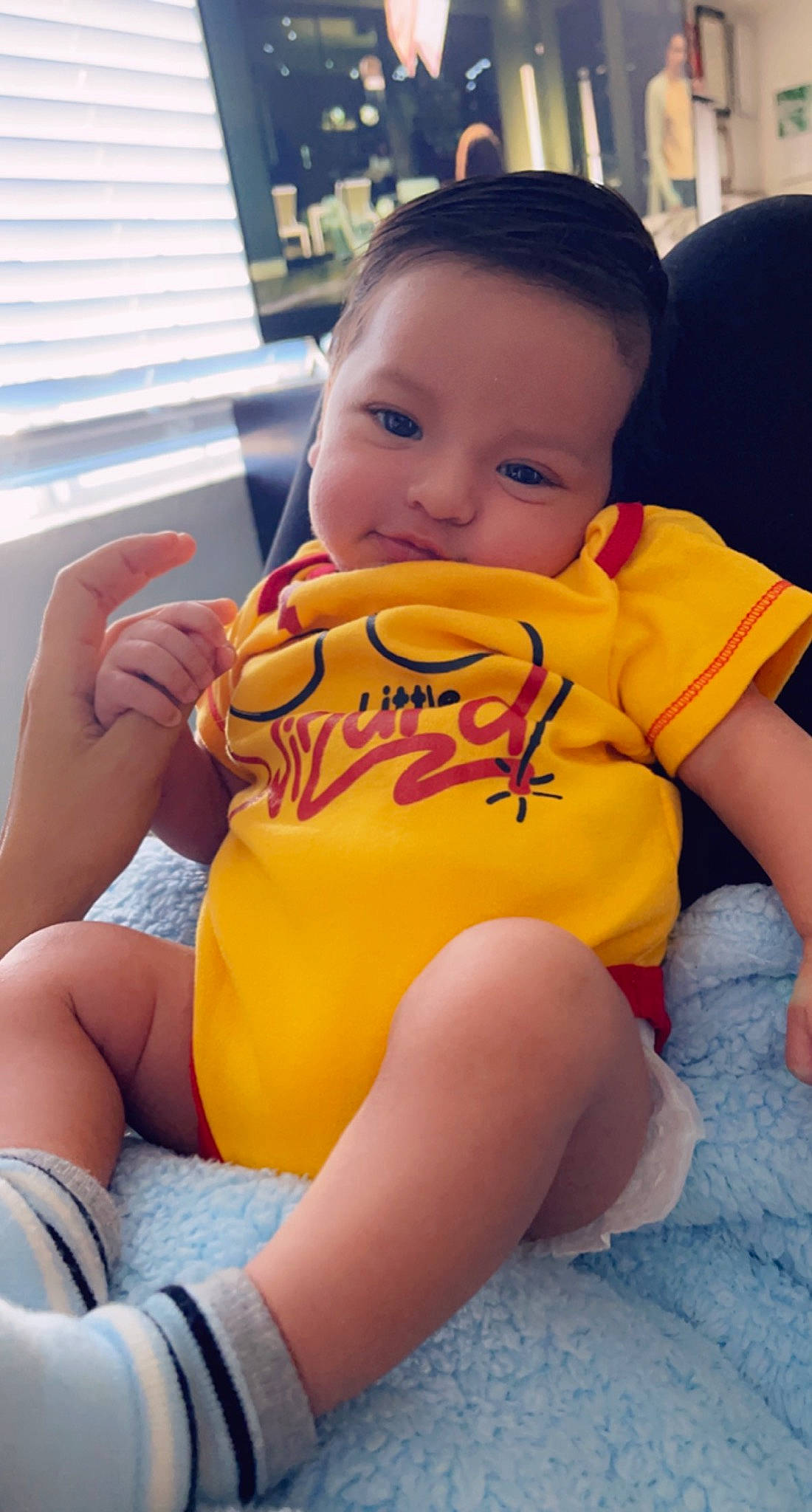 Emilio is registered to the contest to win money with this photo: baby_toddler_clothing, eye, facial_expression, finger, hairstyle, happy, human_body, joint, knee, leg, mouth, muscle, neck, orange, person, shorts, shoulder, skin, thigh, toddler