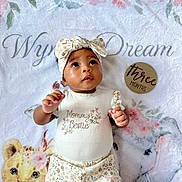 Wynter joined the competition — help win amazing prizes! baby, infant, child, headband, floral, blanket, leopard, elephant, wooden_disc, three_months, cute, portrait, lying_down, clothing, patterned_pants, smiling, eyes, skin, baby_girl, soft_texture