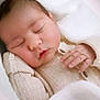 baby, blanket, child, closed_eyes, comfort, cozy, cute, face, hand, indoor, infant, knitwear, newborn, peaceful, portrait, resting, skin, sleeping, soft, warm