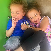 Aria is registered to the contest to win money with this photo: blue_shirt, candid, casual_clothing, child, children, closeup, curly_hair, friendship, fun, happy, hug, joy, leggings, outdoor, pink_shoes, play, playground, smile, toddler, young