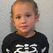 Elijah joined the competition — help win amazing prizes! child, boy, curly_hair, black_shirt, skeleton_print, pink_heart, portrait, indoor, wall, young, cute, smile, face, eyes, head, clothing, standing, person, casual, texture