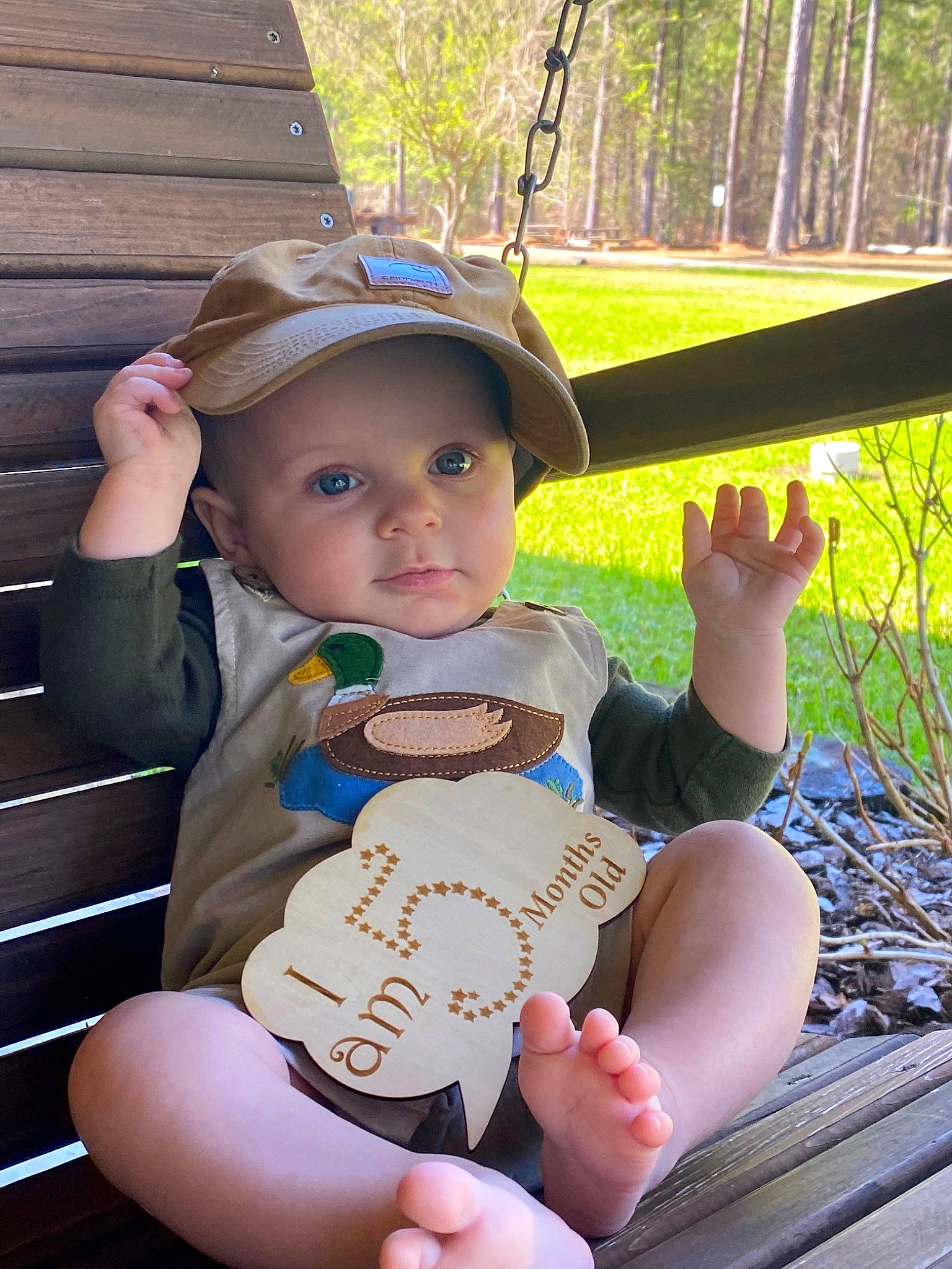 Daxton is registered to the contest to win money with this photo: arm, baby_toddler_clothing, baseball_cap, cap, finger, fun, grass, hand, happy, hat, headwear, leisure, person, plant, shade, skin, summer, sun_hat, thigh, thumb