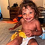 toddler, child, diaper, smile, indoor, carpet, duckling, animal, pet, cute, happy, baby, person, furniture, cabinet, toy, floor, home, playful, curly_hair