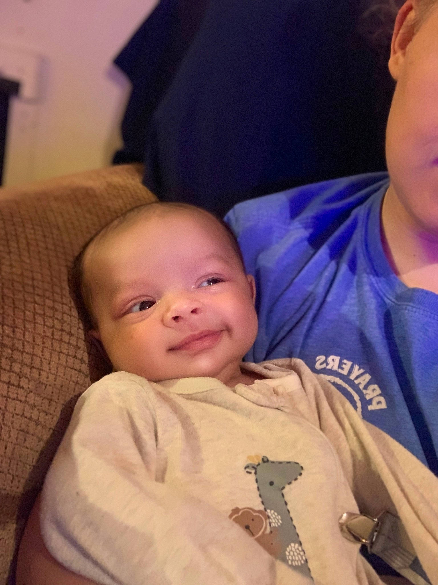 Kamari is registered to the contest to win money with this photo: baby, baby_toddler_clothing, cheek, child, comfort, finger, forehead, fun, happy, head, iris, lap, mouth, nose, person, sitting, skin, sleeve, smile, t_shirt