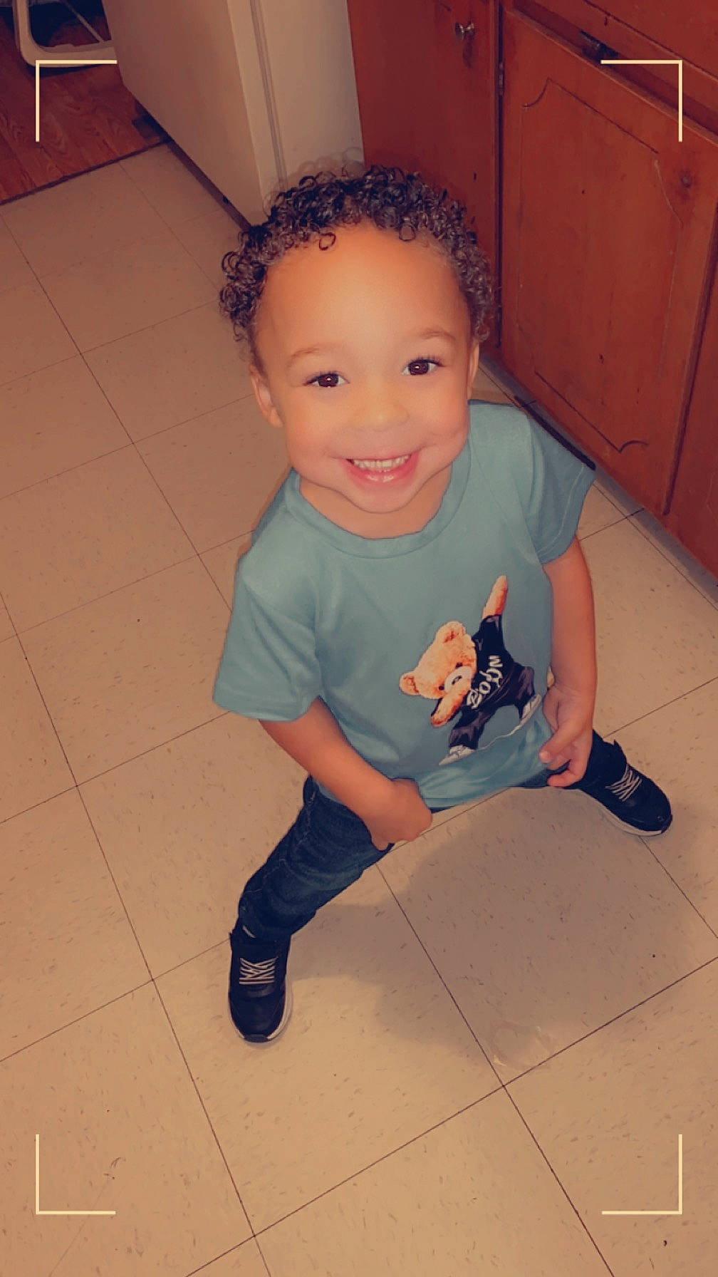 Kaiden is registered to the contest to win money with this photo: arm, baby_toddler_clothing, cabinetry, cheek, eye, face, finger, flash_photography, floor, flooring, happy, human_body, joint, joy, knee, leg, neck, person, shoulder, skin