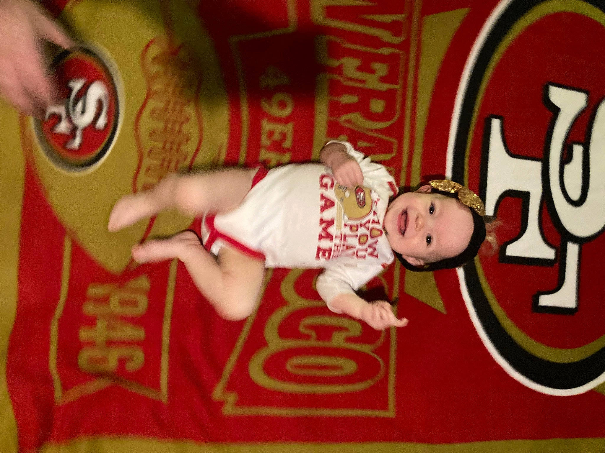 Ava Grace is registered to the contest to win money with this photo: baby, baby_toddler_clothing, carmine, child, elbow, event, font, fun, happy, joy, logo, person, room, sleeve, sports_jersey, sportswear, t_shirt, toddler, wrist