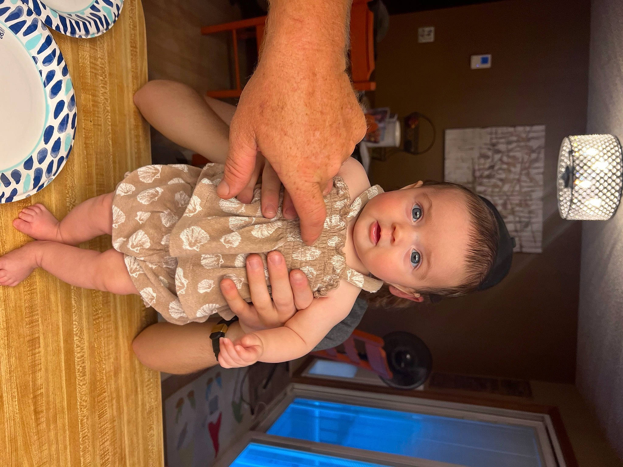 Tenley is registered to the contest to win money with this photo: abdomen, baby, baby_toddler_clothing, barefoot, child, dress, foot, fun, gesture, happy, human_leg, mouth, nail, pattern, person, thigh, thumb, toddler, trunk, wood