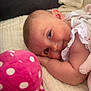 baby, child, plush_toy, pink, polka_dots, blanket, soft, smile, face, head, arm, resting, couch, home, comfort, cute, infant, closeup, sleepy, relaxed