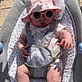 Cataleya a rejoint le concours — aidez-le/la à gagner de superbes lots ! baby, infant, sunglasses, hat, baby_bouncer, toy, outdoor, sunlight, floral_onesie, pink, heart_pattern, cute, child, summer, sitting, playful, tongue_out, shade, comfort, happy