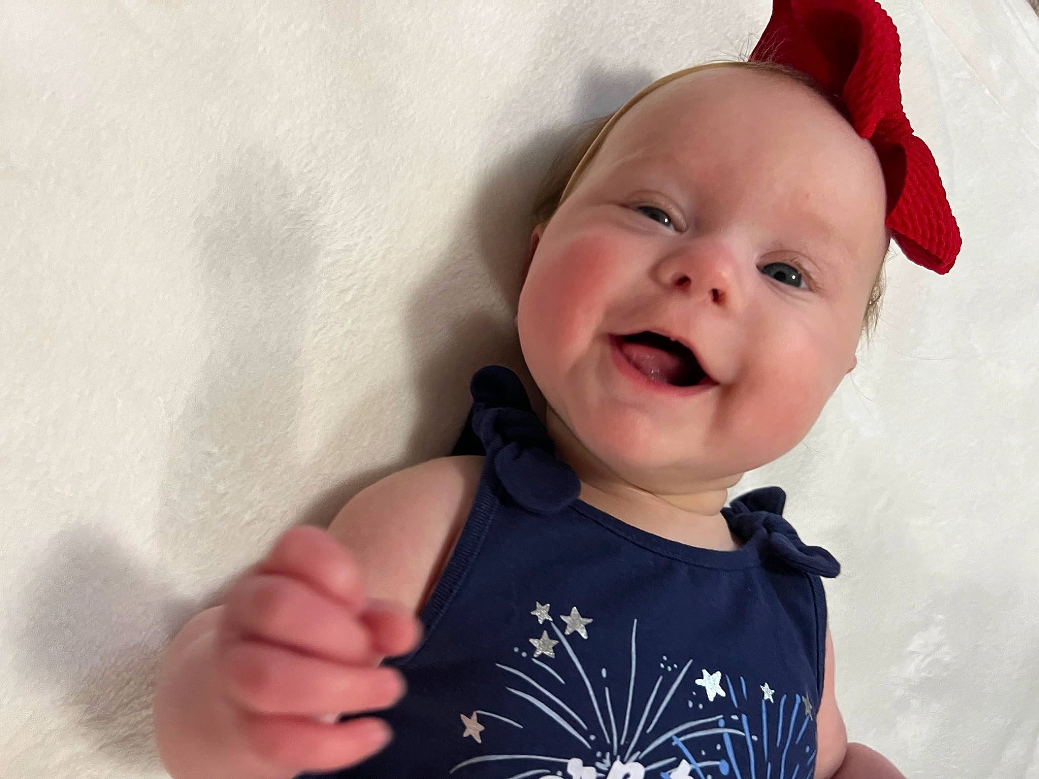 Ellie is registered to the contest to win money with this photo: baby, baby_laughing, baby_toddler_clothing, cap, cheek, child, eye, face, finger, fun, gesture, happy, head, headwear, lip, person, skin, sleeve, smile, t_shirt