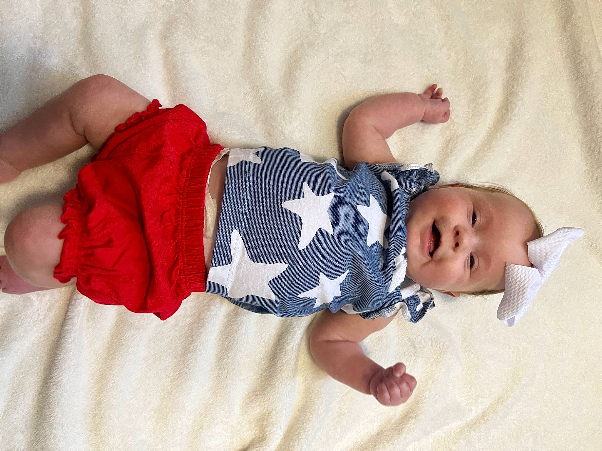 Ellie is registered to the contest to win money with this photo: arm, baby, baby_sleeping, baby_toddler_clothing, comfort, finger, hand, headgear, human_body, leg, linens, mammal, pattern, person, product, skin, sleeve, sock, textile, toddler