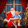 baby, child, santa_claus, christmas_tree, holiday, festive, red_curtains, window, ornaments, lights, chair, smile, indoor, celebration, winter, decoration, person, beard, costume, happy