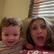 Tevy joined the competition — help win amazing prizes! child, woman, smile, surprised, couch, indoor, window_blinds, casual_clothing, curly_hair, long_hair, facial_expression, portrait, family, toddler, living_room, happy, person, home, light, relaxed