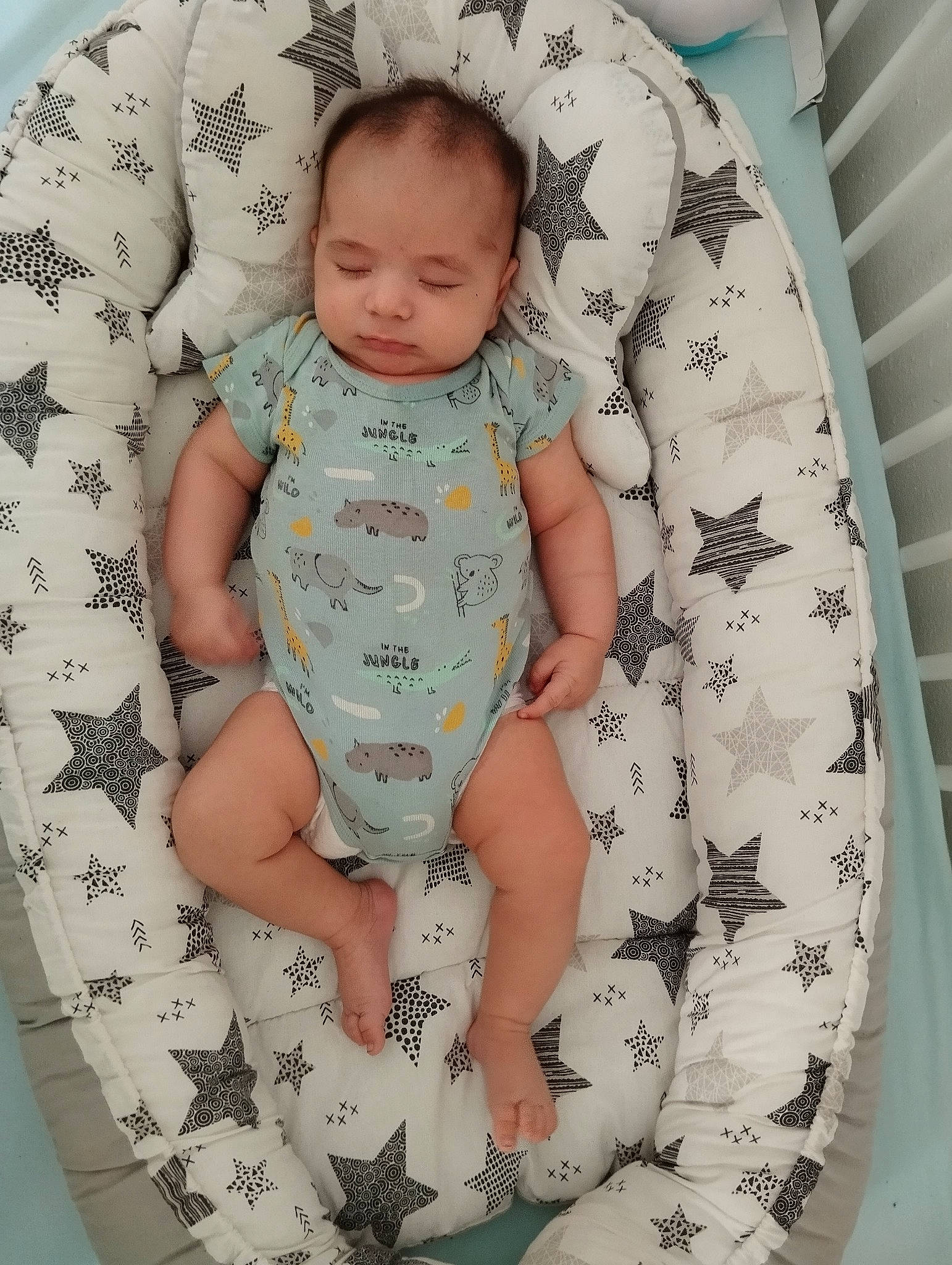 Hassan participe au concours pour gagner de l'argent avec cette photo : arm, baby, baby_products, baby_toddler_clothing, child, comfort, face, hand, head, human_body, infant_bodysuit, leg, linens, pattern, person, product, sleeve, textile, thigh, toddler