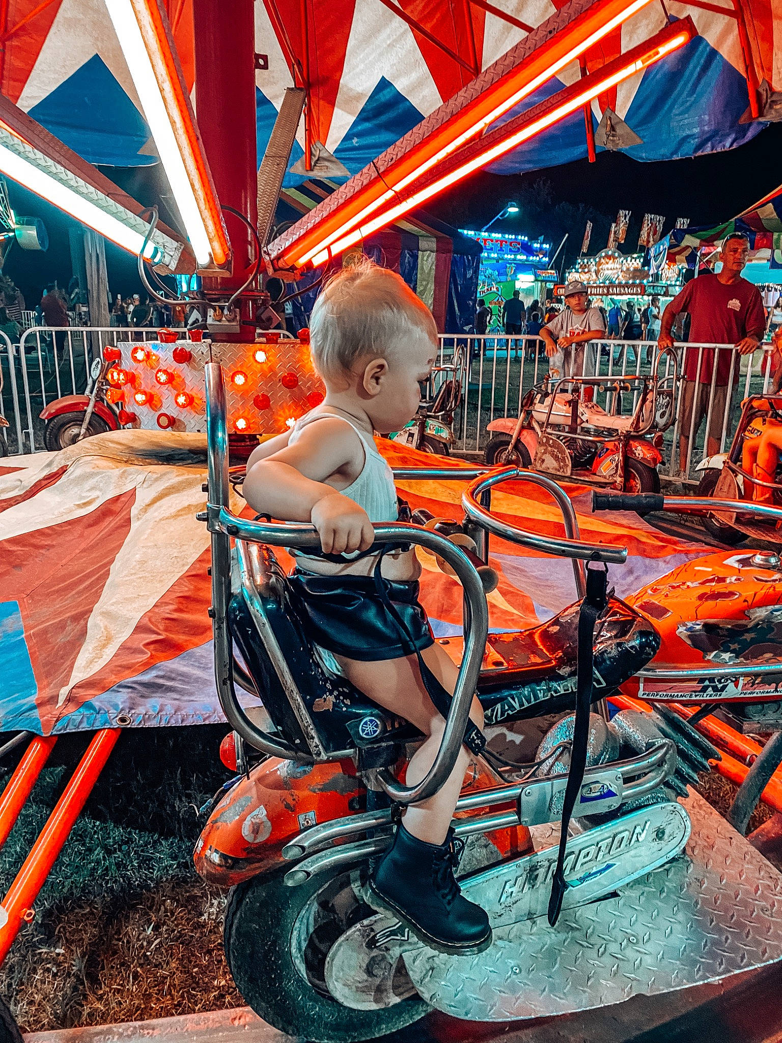 Lauren is registered to the contest to win money with this photo: automotive_design, automotive_lighting, automotive_tire, automotive_wheel_system, bicycle_tire, city, electric_blue, fun, human_settlement, leisure, mode_of_transport, motor_vehicle, orange, person, public_space, recreation, riding_toy, tire, toddler, vehicle