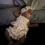 Kylahna joined the competition — help win amazing prizes! baby, infant, pacifier, headband, floral_outfit, bed, pillow, sleepwear, child, lying_down, cute, indoors, peaceful, resting, soft_lighting, portrait, young_child, fabric, texture, relaxing