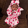 Kylahna joined the competition — help win amazing prizes! baby, infant, pink_robe, strawberry_pattern, hood, bow, couch, brown_couch, patterned_fabric, sitting, cute, child, indoors, soft_texture, feet, clothing, warm, young_child, portrait, relaxed