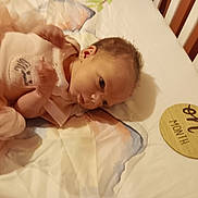 Alexandria joined the competition — help win amazing prizes! baby, infant, crib, blanket, wooden_sign, one_month, pink_clothing, lying_down, newborn, nursery, cute, small_hands, soft_fabric, head, face, sleeping_area, baby_girl, bed, infant_clothing, child
