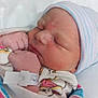 Alexandria is registered to the contest to win money with this photo: newborn, baby, infant, sleeping, hospital, blanket, cap, wrapped, fist, closeup, skin, bed, clothing, person, child, cute, resting, healthcare, soft, peaceful