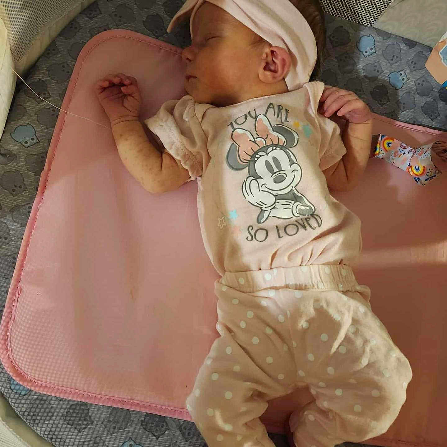 Alexandria joined the competition — help win amazing prizes! adorable, baby, child, cozy, cute, headband, indoors, infant, mat, minnie_mouse, patterned_padding, peaceful, pink_clothing, playpen, polka_dot_pants, resting, sleeping, small_feet, small_hands, soft_lighting