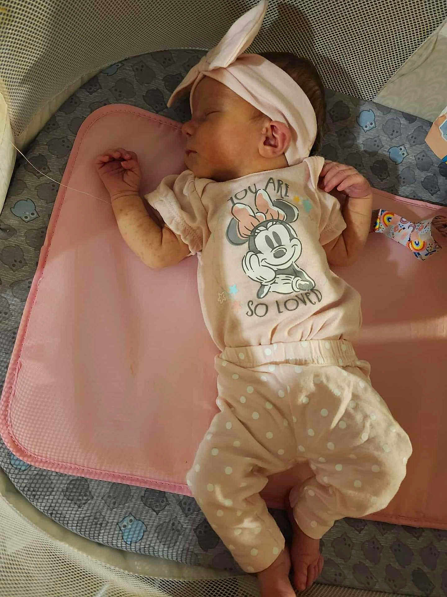 Alexandria joined the competition — help win amazing prizes! baby, sleeping, infant, headband, pink_clothing, polka_dot_pants, minnie_mouse, playpen, mat, cute, peaceful, child, small_hands, small_feet, patterned_padding, soft_lighting, indoors, resting, cozy, adorable