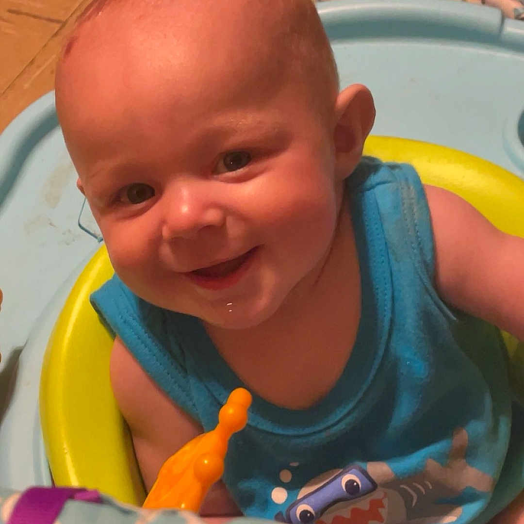Sebastian is registered to the contest to win money with this photo: baby, clothing, cream, cutlery, dessert, face, food, happy, head, icing, laughing, person, photography, plant, portrait, pottedplant, smile, spoon, t_shirt, tape