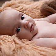 Raphaël participe au concours pour gagner de l'argent avec cette photo : baby, blanket, child, closeup, cozy, cute, expression, eyes, face, indoors, infant, lying_down, natural_light, newborn, peaceful, portrait, resting, skin, soft_texture, warm