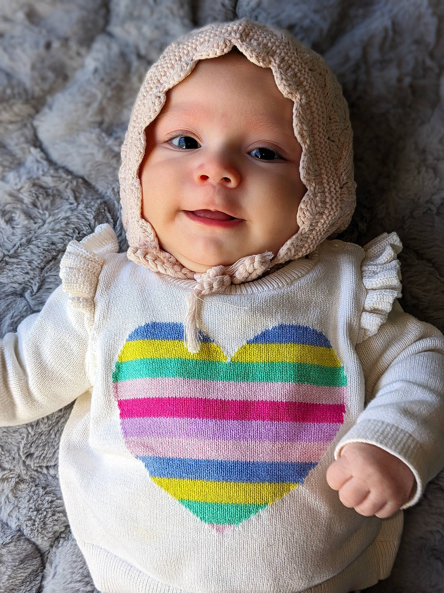 Esmeralda is registered to the contest to win money with this photo: baby, baby_toddler_clothing, cheek, clothing, eye, face, grey, happy, headwear, iris, knit_cap, lip, outerwear, pattern, person, skin, sleeve, smile, textile, toddler