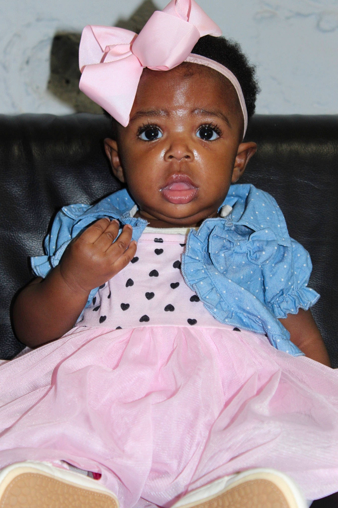 Naomi is registered to the contest to win money with this photo: baby, baby_toddler_clothing, cheek, child, chin, eyebrow, eyelash, fashion_accessory, fun, happy, head, lip, nose, pattern, person, pink, sitting, skin, sleeve, t_shirt