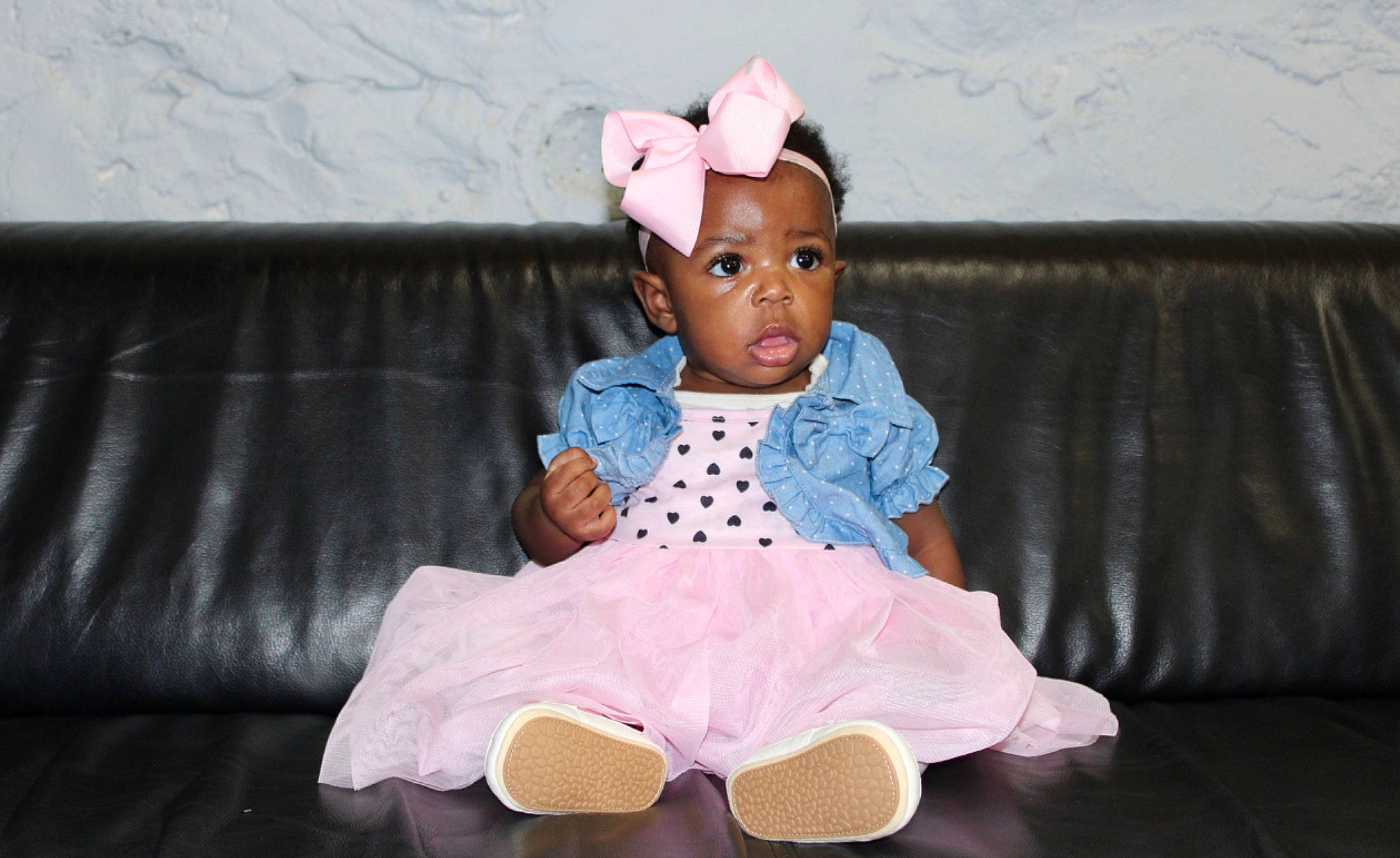 Naomi is registered to the contest to win money with this photo: baby_toddler_clothing, child, costume, couch, doll, eye, fashion_accessory, fur, hat, headband, headpiece, magenta, pattern, person, pink, room, sitting, sleeve, stuffed_toy, toddler