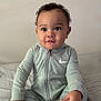 baby, child, infant, curly_hair, sitting, bed, clothing, nike, hoodie, foot, hand, wooden_sign, ten_months, portrait, cute, indoors, soft_light, expression, person, young