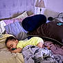 baby, sleeping, bed, blanket, pillow, pacifier, onesie, headboard, lamp, indoors, cozy, rest, child, curly_hair, soft_lighting, toddler, furniture, comfort, nap, home