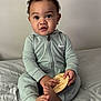 baby, child, infant, onesie, nike, bed, plaque, foot, hand, curly_hair, indoor, portrait, cute, expression, sitting, young, person, clothing, skin, face