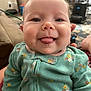baby, babylaughing, bodypart, clothing, coat, couch, face, furniture, happy, head, jacket, knitwear, laughing, mouth, person, photography, portrait, smile, sweater, teeth
