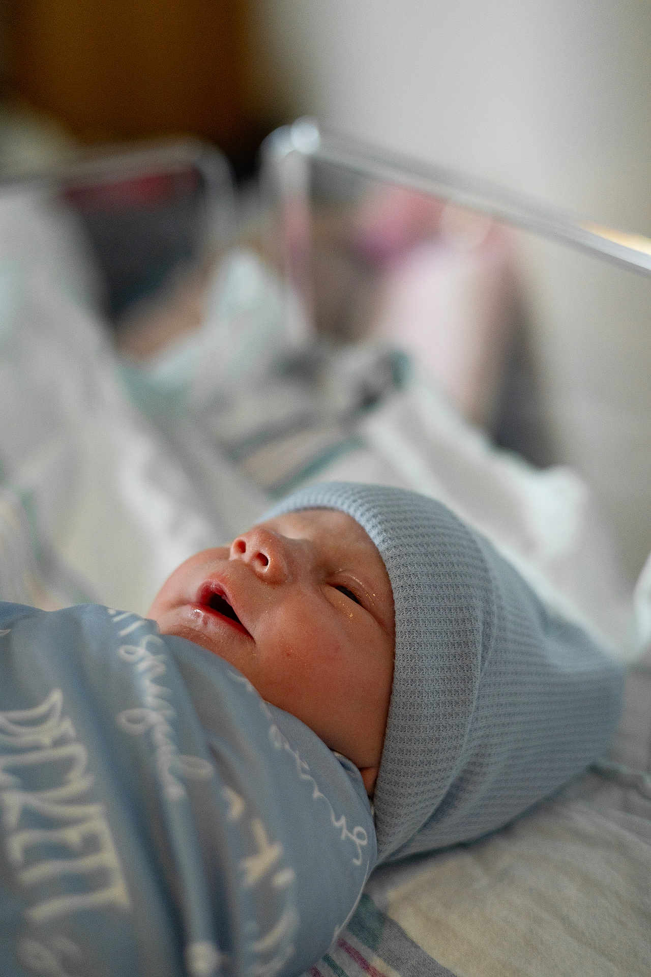 Beckett joined the competition — help win amazing prizes! newborn, baby, swaddle, beanie, hat, crib, hospital, infant, portrait, close_up, soft_light, bokeh, sleepy, mouth_open, blanket, skin, nursery, cozy, portrait_photography, tiny_person