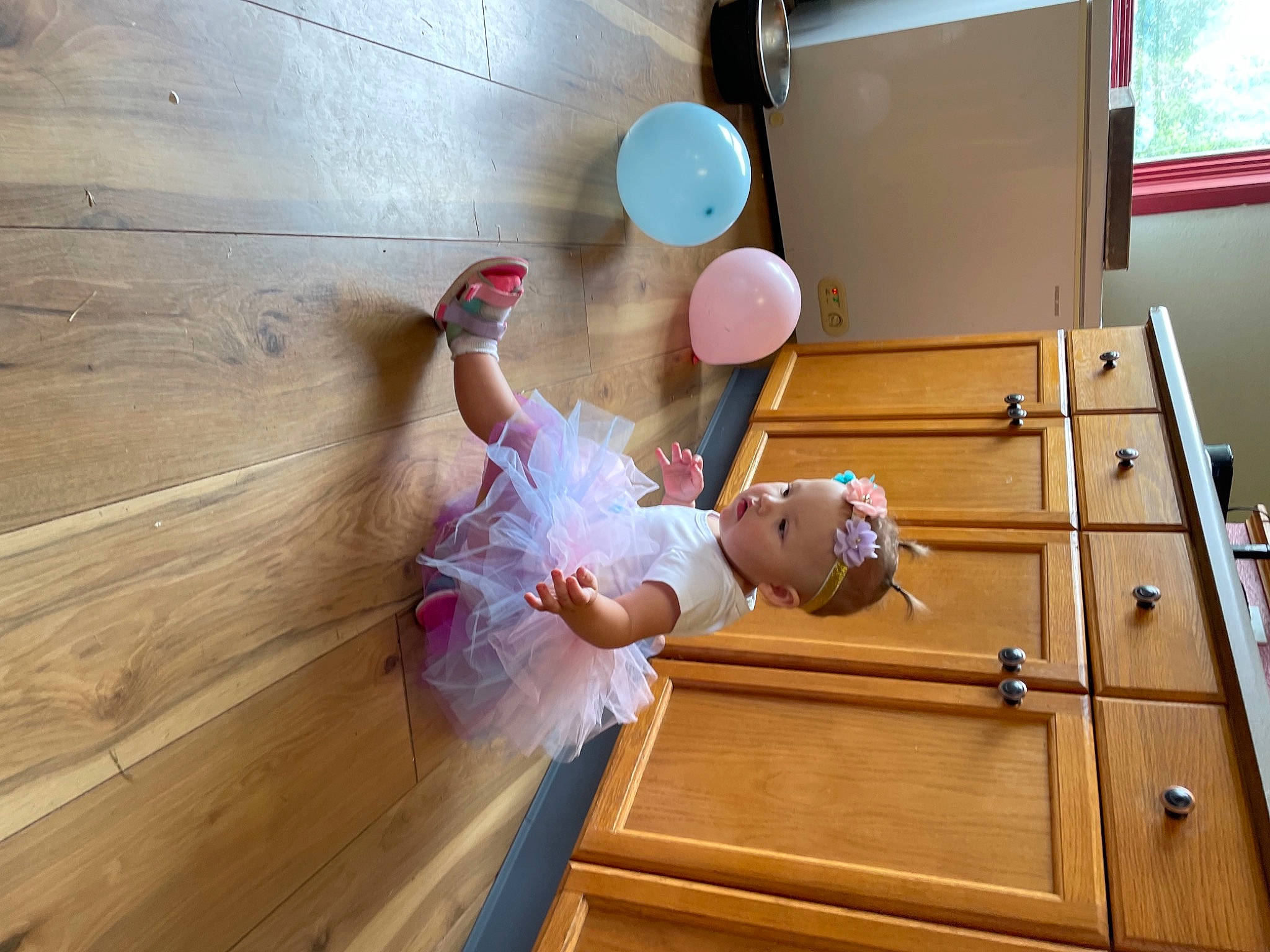 Lillianna is registered to the contest to win money with this photo: dress, floor, flooring, fun, happy, hardwood, human_leg, leisure, person, plywood, recreation, room, stairs, table, thigh, toddler, varnish, window, wood, wood_flooring