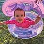 érina a rejoint le concours — aidez-le/la à gagner de superbes lots ! baby, child, inflatable_ring, water, clear_water, rocks, pink_clothing, purple_inflatable, hand, sunlight, outdoor, smiling, happy, floating, summer, playful, person, swimwear, nature, fun