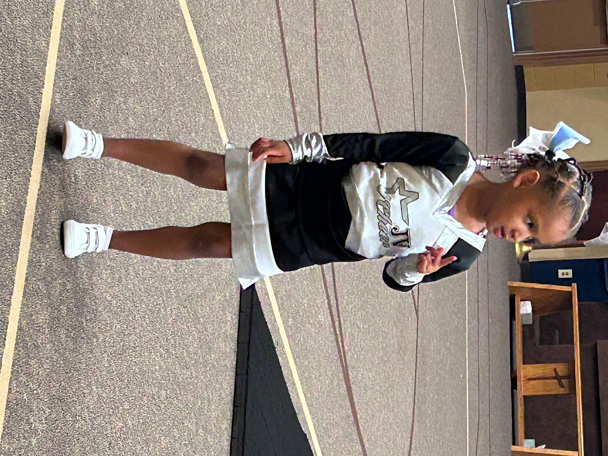 Tanji is registered to the contest to win money with this photo: asphalt, boot, fun, hat, human_leg, knee, leg, outdoor_shoe, pedestrian, person, recreation, road, road_surface, rolling, shadow, shorts, sidewalk, sneakers, thigh, toddler