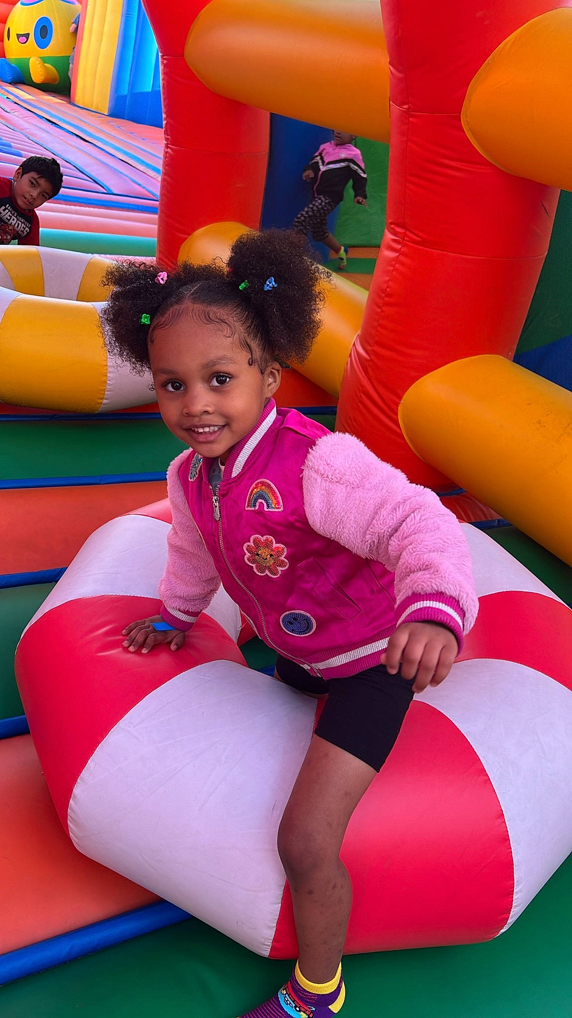 Maleah is registered to the contest to win money with this photo: child, comfort, fun, glove, happy, human_leg, inflatable, joy, knee, leg, leisure, magenta, person, pink, recreation, red, smile, sportswear, textile, thigh