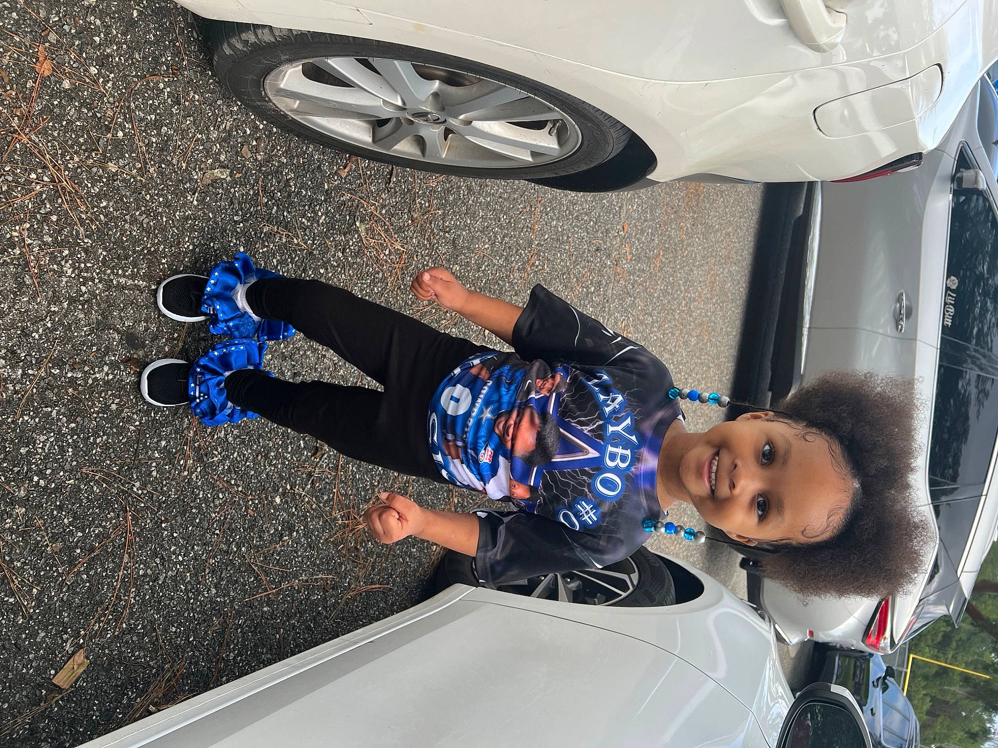 Maleah joined the competition — help win amazing prizes! asphalt, automotive_design, automotive_exterior, automotive_lighting, automotive_tire, automotive_wheel_system, bumper, car, electric_blue, fender, hood, joy, light, motor_vehicle, person, rim, tire, toddler, vehicle, vehicle_door
