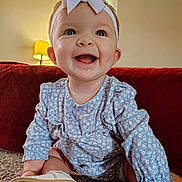 Brylee Grace is registered to the contest to win money with this photo: baby, blue_dress, bow, carpet, child, clothing, couch, cute, face, happy, headband, home, indoor, infant, lamp, person, portrait, sitting, smiling, toddler