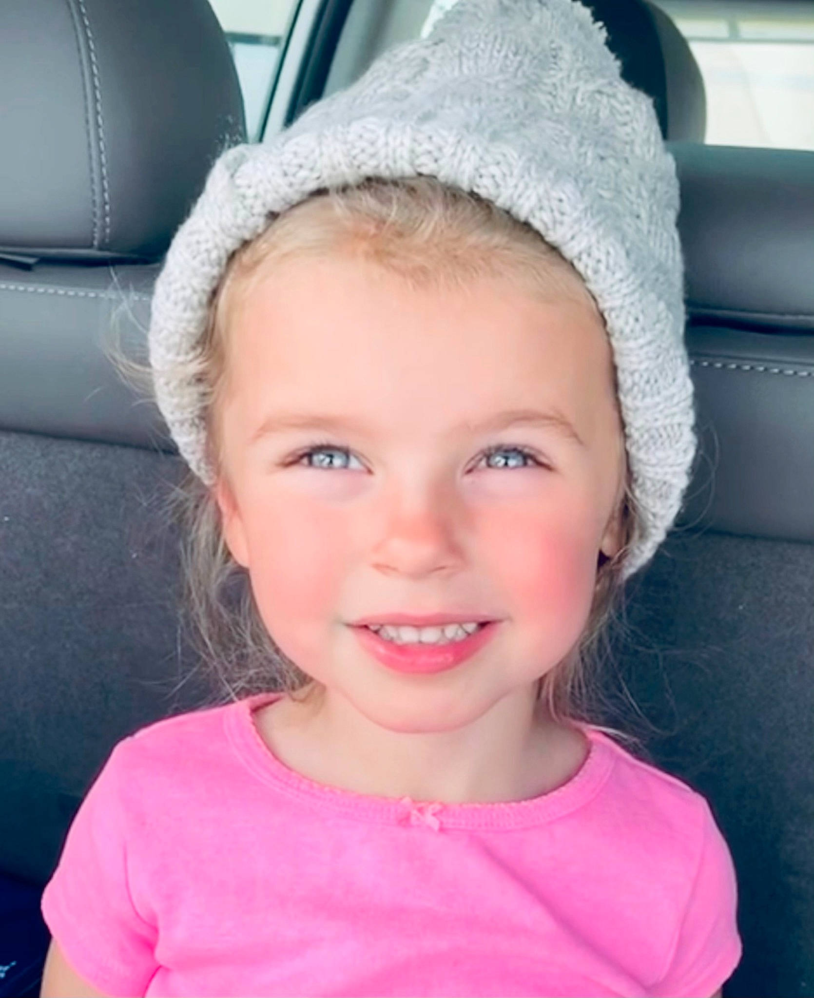 Scarlette is registered to the contest to win money with this photo: baby_toddler_clothing, car_seat, cheek, child, chin, eye, facial_expression, happy, head_restraint, iris, joy, lip, magenta, mouth, nose, person, pink, skin, smile, toddler