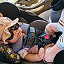 Ian is registered to the contest to win money with this photo: accessory, baby, baby_shoes, car_seat, casual_clothing, child, cushion, cute, floral_pattern, footwear, hat, headwear, indoors, infant, person, relaxed, safety_harness, seatbelt, socks, sunglasses