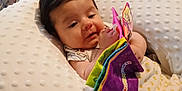 Ian is registered to the contest to win money with this photo: baby, bed, blanket, child, colorful, comfort, cozy, curious, cute, fabric_book, indoors, infant, pattern, person, pillow, plaid, playing, resting, soft_texture, young_child